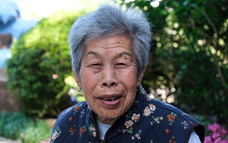 Elderly Chinese woman posing in public park